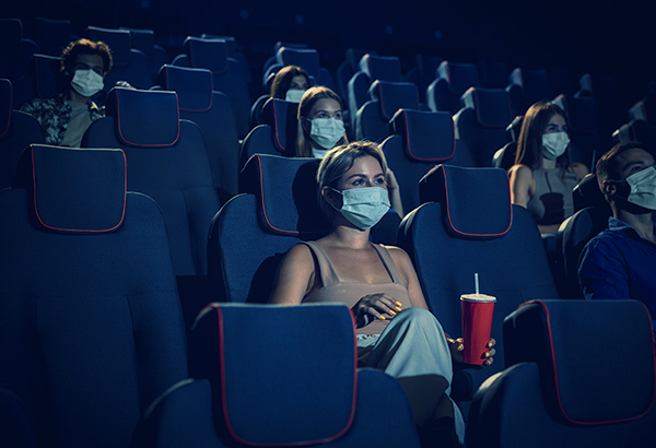 Guests inside cinema wearing masks 